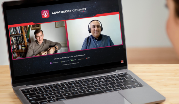 A laptop on a table displaying the low-code podcast featuring Angus Kennedy