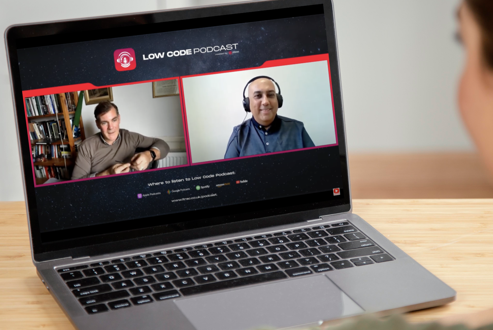 A laptop on a table displaying the low-code podcast featuring Angus Kennedy