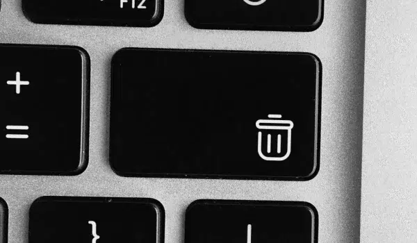 Zoomed in top view of a laptop keyboard, focusing on a 'delete' button.