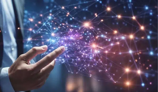 A businessman pointing at and interacting with a network of glowing nodes that represent technological connectivity.