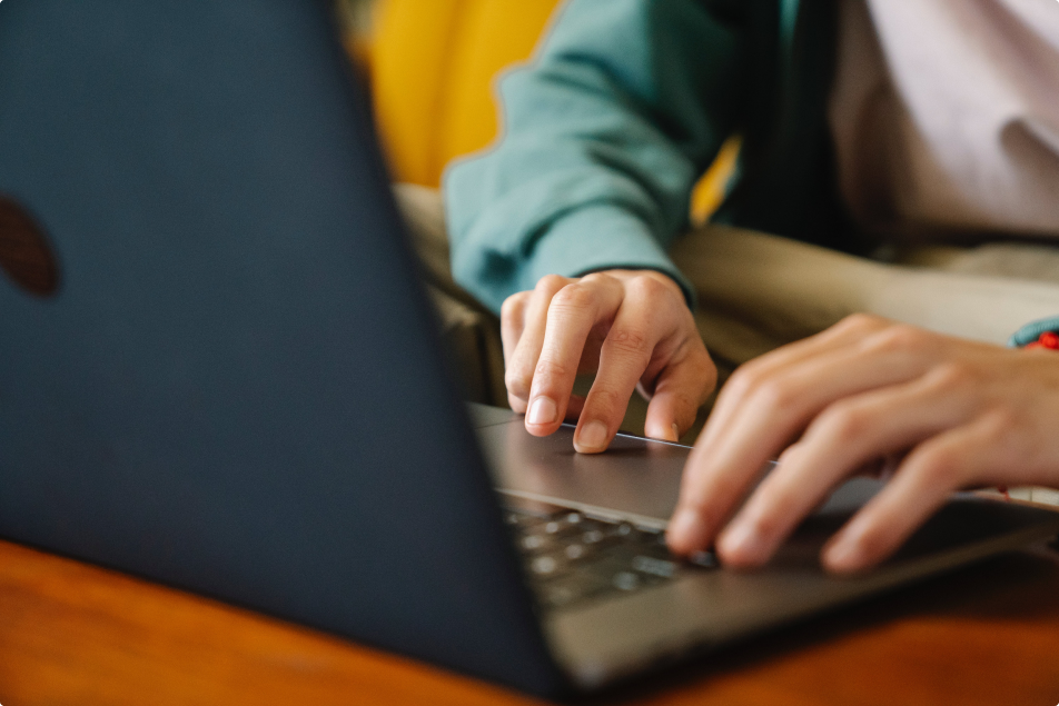 A zoomed in image of a user typing on a laptop